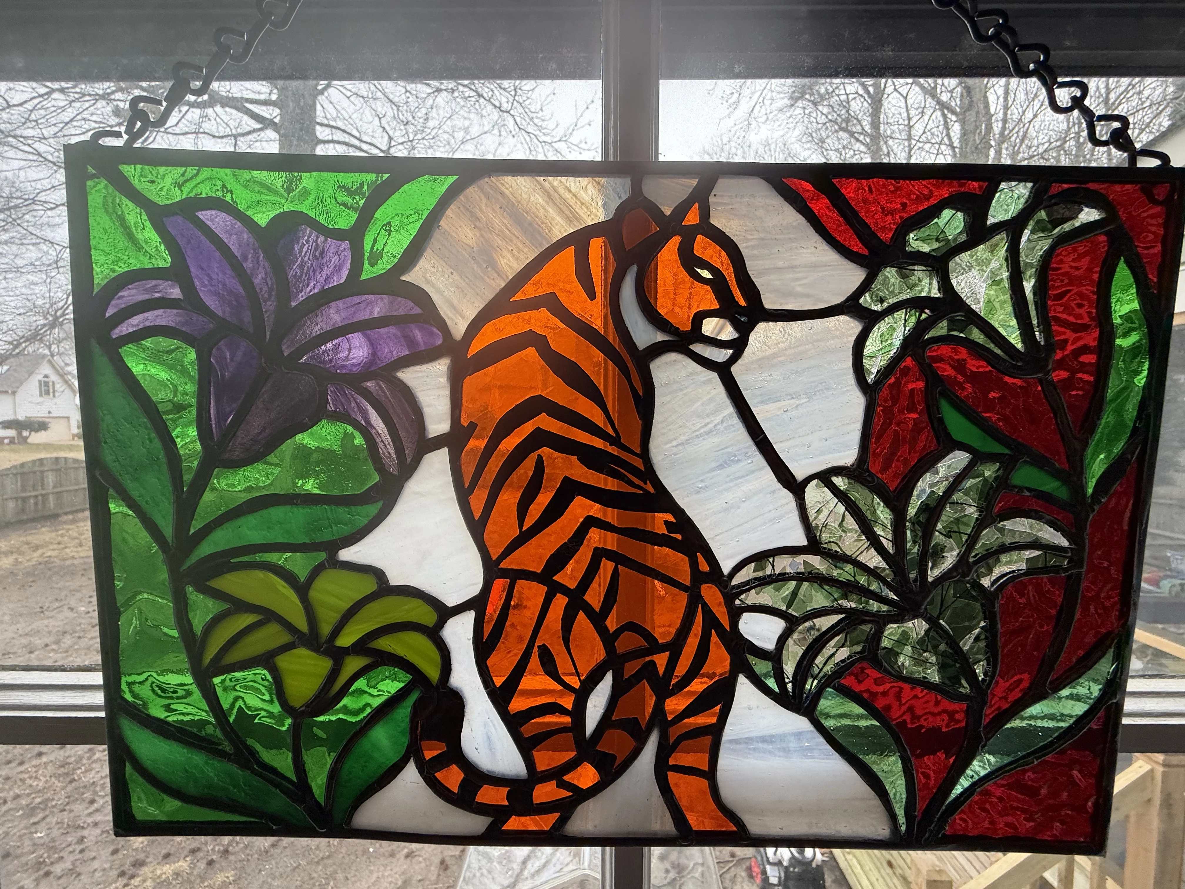 Artist working on stained glass panel